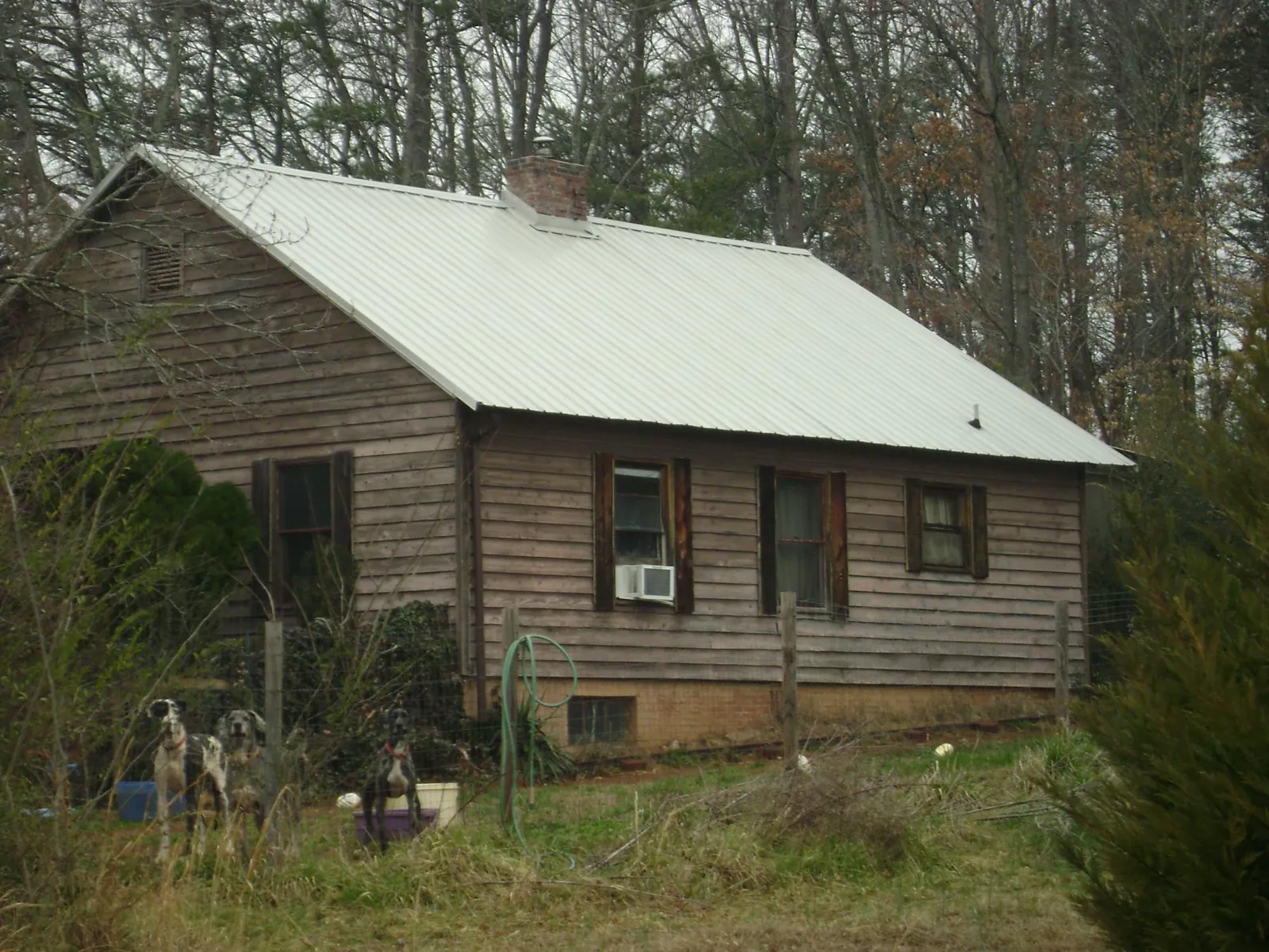 White metal roof on an old wood sided farmhouse, from a Metal Roof Installation job in Addison