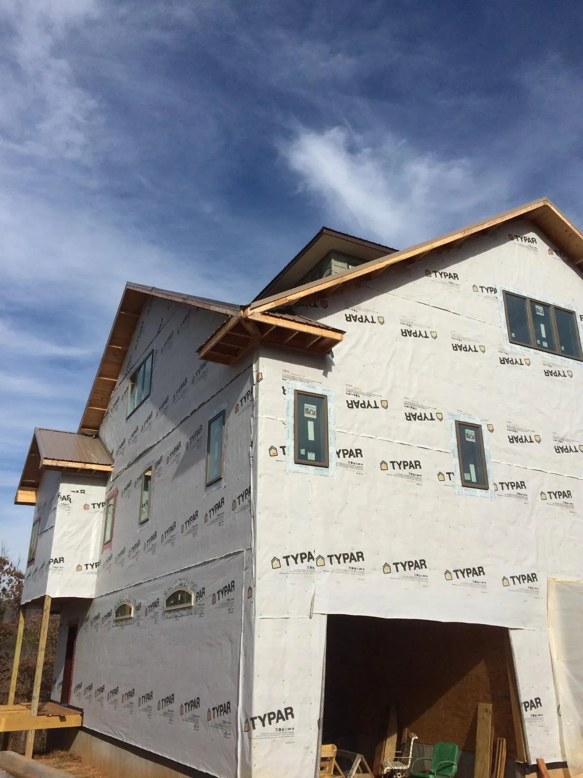 Stick built house wrapped in Typar with new roof framing and dormers in Addison